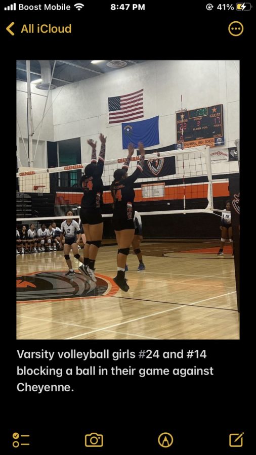 Varsity players Taimane Laolagi-Aloy, junior, and Tehjana Fonoti Laolagi, senior, jump up in unison to block the ball heading towards the net. 