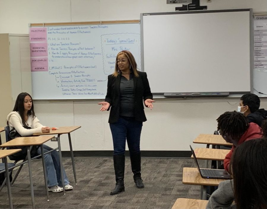 Fulfillment Fund Representative Victoria Parker speaks to members of the Ms. Farmer's Freshman Studies' class about what opportunities they should take advantage of while in high school.