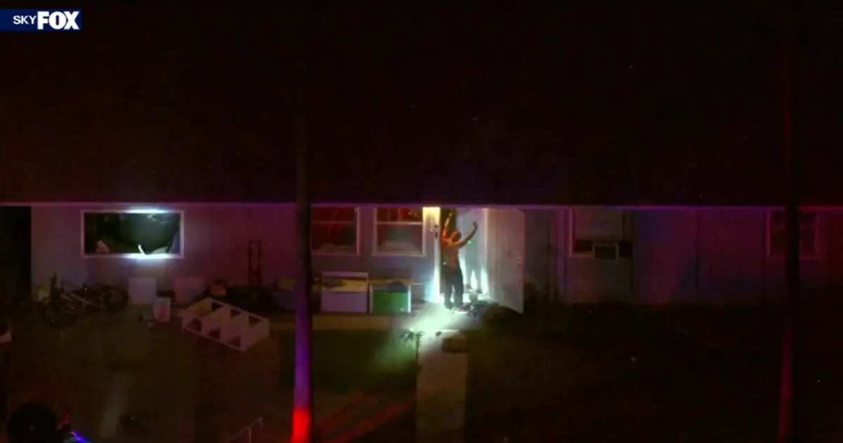 Police officers near a home in Queen Creek during a barricade situation